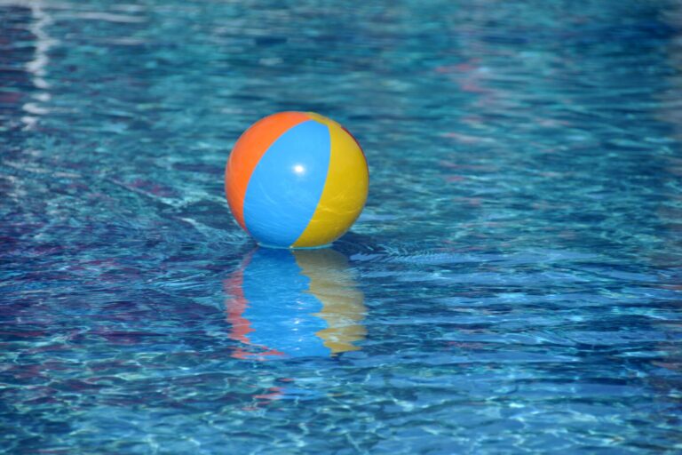 Beach ball floating on water, representing resilience and the ability to stay afloat through changing market conditions.